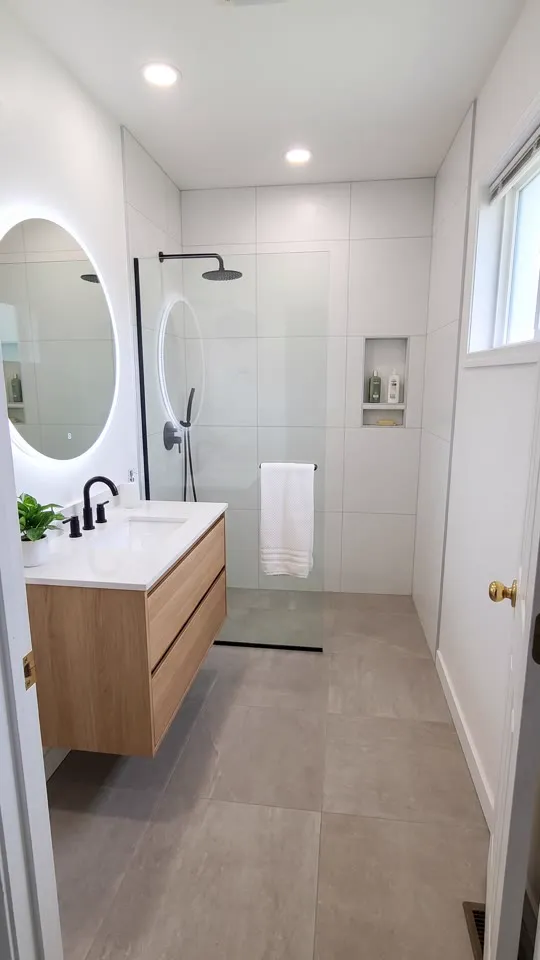 Finished bathroom with a curbless walk-in shower and floating oak vanity